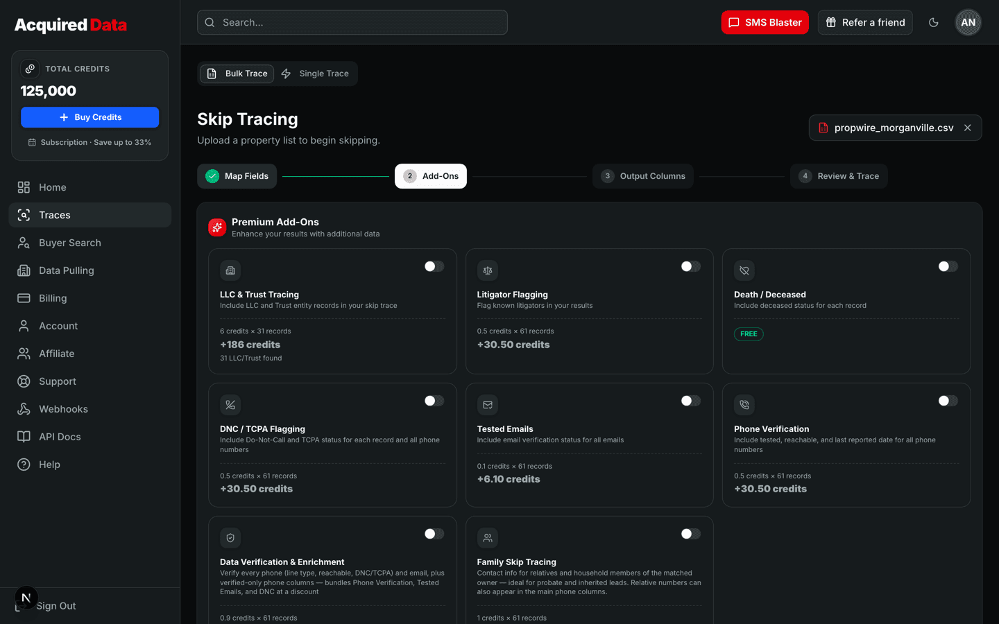 The Add-Ons step showing premium add-on cards — LLC & Trust Tracing, Litigator Flagging, Death/Deceased, DNC/TCPA Flagging, Tested Emails, Phone Verification, Data Verification & Enrichment, and Family Skip Tracing — each with a toggle, per-row price, and a live credit subtotal for the uploaded list.