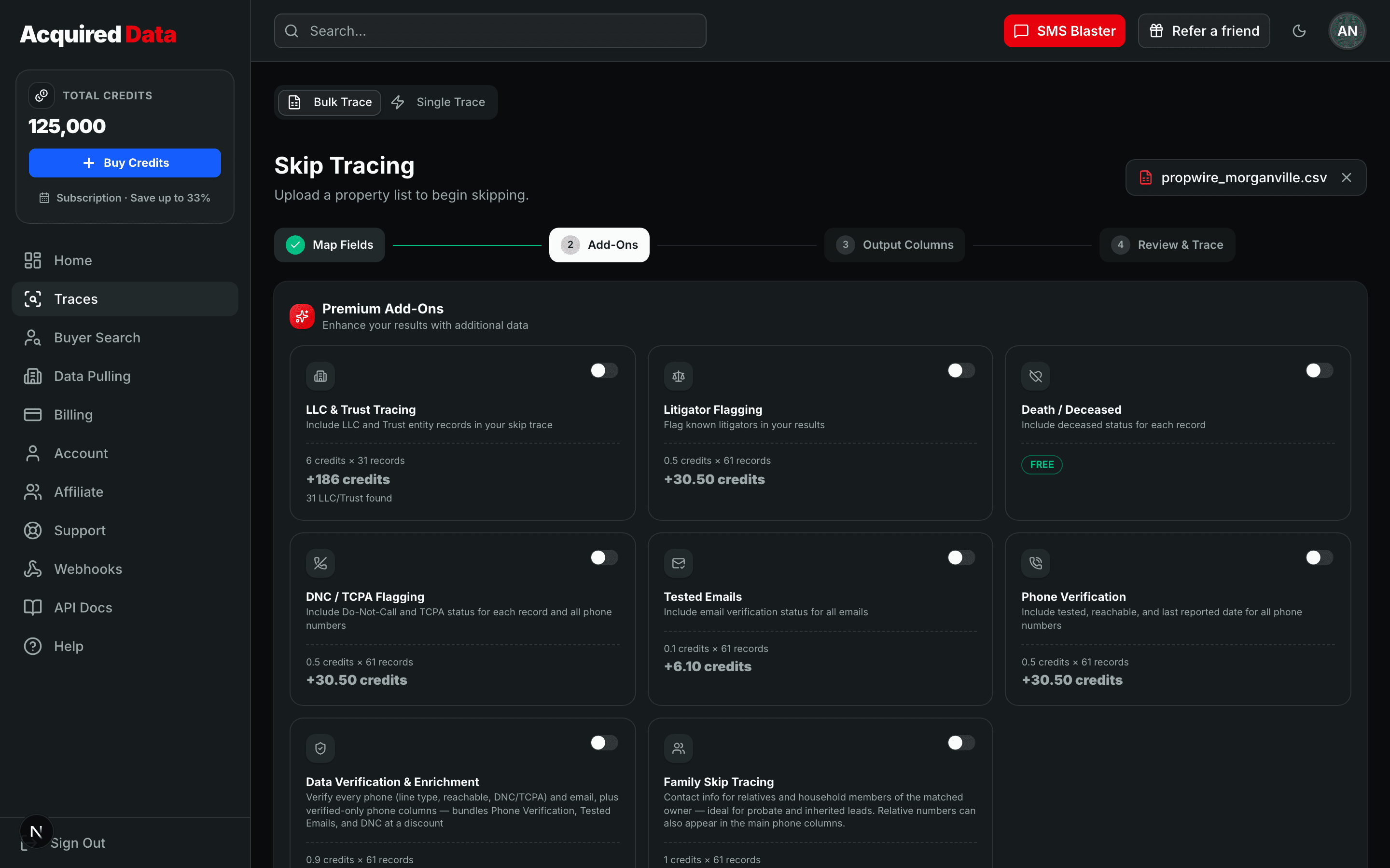 The Add-Ons step showing premium add-on cards — LLC & Trust Tracing, Litigator Flagging, Death/Deceased, DNC/TCPA Flagging, Tested Emails, Phone Verification, Data Verification & Enrichment, and Family Skip Tracing — each with a toggle, per-row price, and a live credit subtotal for the uploaded list.